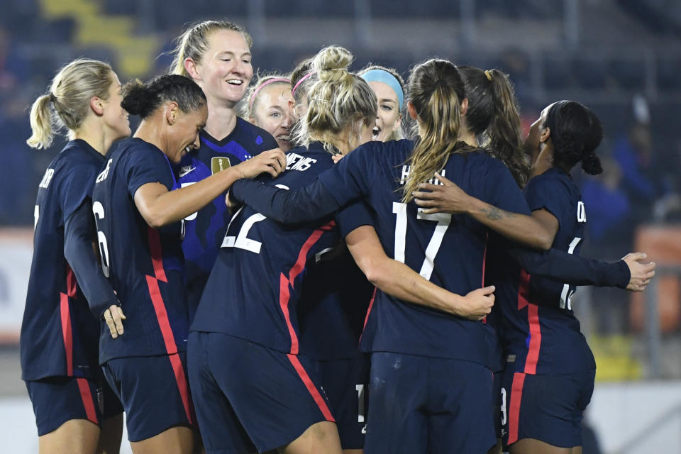 United States players celebrate with Kristie Mewis, number 22, who scored her side's second goal during the international friendly women's soccer match between The Netherlands and the US at the Rat Verlegh stadium in Breda, southern Netherlands, Friday Nov. 27, 2020. (Piroschka van de Wouw/Pool via AP)