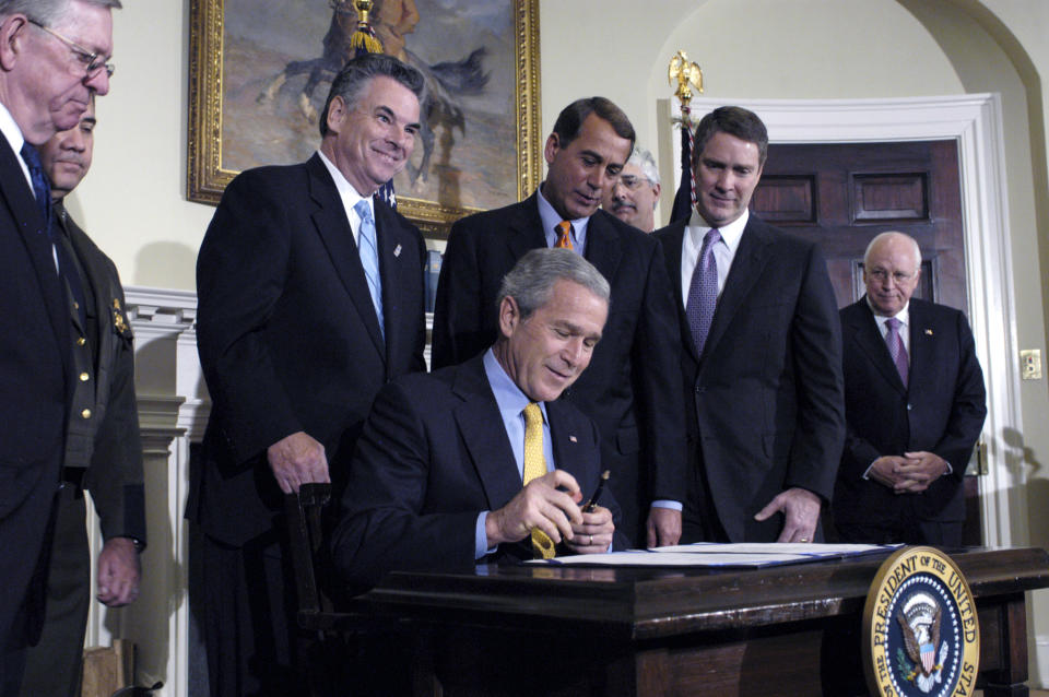 UNITED STATES - OCTOBER 26:  President George W. Bush signs the Secure Fence Act of 2006 during a Roosevelt Room ceremony at the White House, October 26, 2006 in Washington, D.C. With him from left to right are Ralph Basham, Commissioner of U.S. Customs, David Aguilar, Chief of U.S. Border and Customs Protection, Representative Peter King, Chairman of the Homeland Security Committee, House Majority Leader John Boehner, Michael Jackson, Deputy Director Homeland Security, Senate Majority Leader Bill Frist, and Vice President Dick Cheney. The legislation authorizes the construction of a 700-mile fence along a portion of the U.S.-Mexico border in an effort to curb illegal immigration.  (Photo by Carol T. Powers/Bloomberg via Getty Images)