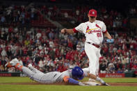 New York Mets' Dominic Smith is safe at first for a single as St. Louis Cardinals relief pitcher Giovanny Gallegos (65) is late to the bag during the ninth inning of a baseball game Monday, April 25, 2022, in St. Louis. The Mets' Travis Jankowski and Jeff McNeil scored on the play. (AP Photo/Jeff Roberson)