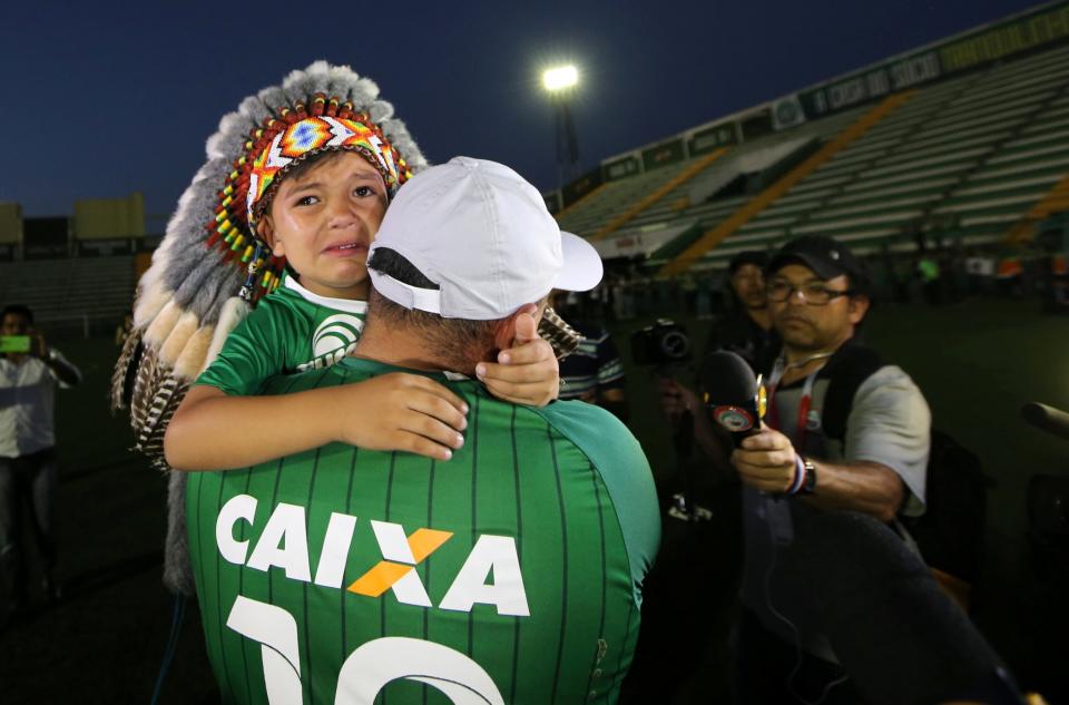 <p>A fan of Chapecoense soccer team and his son react at the Arena Conda stadium in Chapeco, Brazil, November 29, 2016. REUTERS/Paulo Whitaker </p>