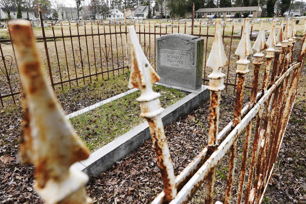 A rusted fence surrounds a tombstones at the Lincoln Memorial Cemetery in Portsmouth, Va., Tuesday, March 23, 2021. (AP Photo/Steve Helber)