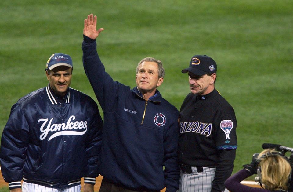 President George W. Bush, standing with New York Yankees' manager Joe Torre (left) and Arizona Diamondbacks manager Bob Brenly acknowledges applause from crowd at Yankee Stadium before start of Game 3 of the World Series on Oct. 30, 2001. (Photo by Howard Earl Simmons/NY Daily News Archive via Getty Images)