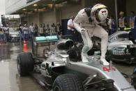 Formula One - F1 - Brazilian Grand Prix - Circuit of Interlagos, Sao Paulo, Brazil - 13/11/2016 - Mercedes' Lewis Hamilton of Britain celebrates atop his car after winning the race. REUTERS/Nacho Doce