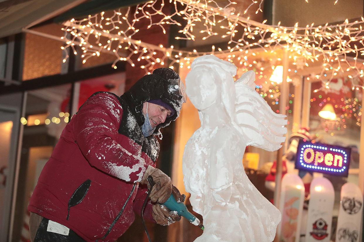 Ice sculptor Tom Blike of Mansfield works on an Angel carving outside of Collective skate shop on 4th ST NW during First Friday in downtown Canton.
