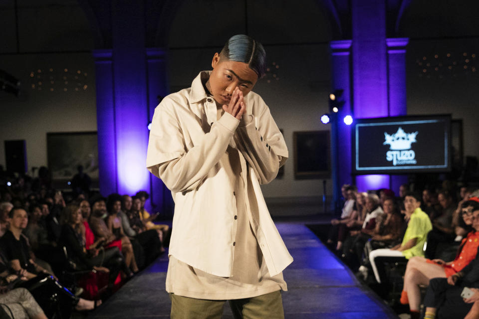 The STUZO collection is modeled during the dapperQ fashion show at the Brooklyn Museum on Thursday Sept. 5, 2019, in New York. (AP Photo/Jeenah Moon)