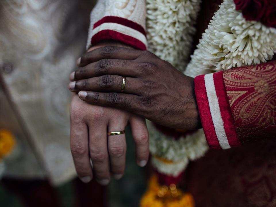 grooms holding hands wedding