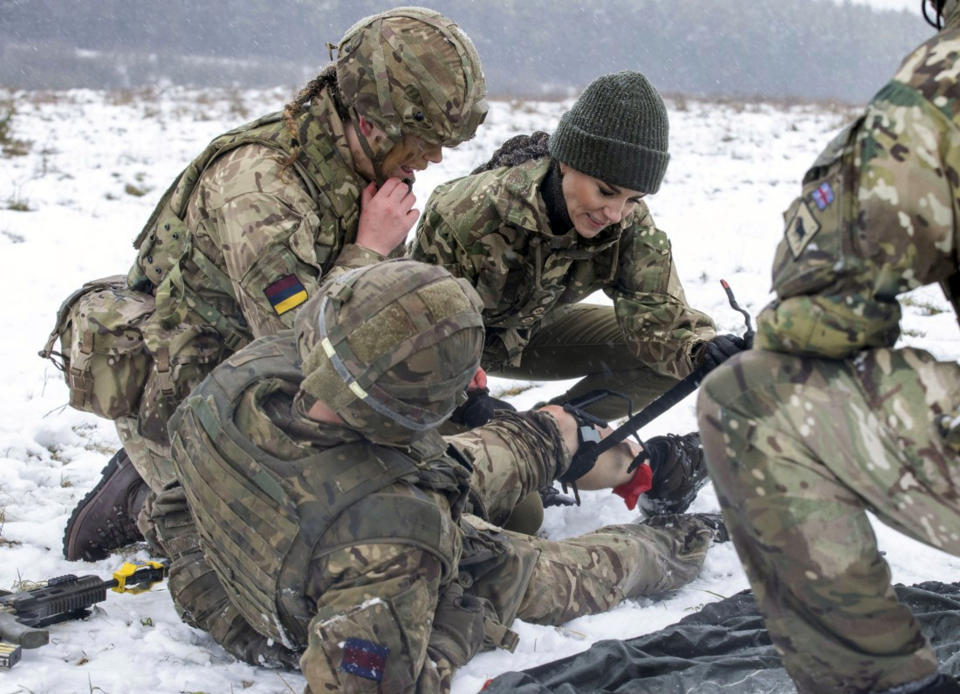 FILE - Britain's Kate, Princess of Wales, Colonel, Irish Guards, is shown how to carry out battlefield casualty drills to deliver care to injured soldiers during a casualty simulation exercise, during her first visit to the 1st Battalion Irish Guards since becoming Colonel, at the Salisbury Plain Training Area in Wiltshire, England, Wednesday March 8, 2023. The U.K. government said Wednesday it has no plans to introduce conscription, after the head of the British Army said a “citizen army” would be needed to fight a future war with a country like Russia. (Steve Reigate/Pool Photo via AP, File)