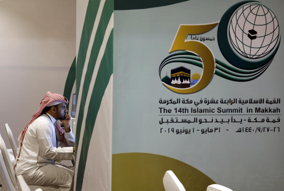 A reporter works at the press center for the upcoming Arab and Islamic summits in Mecca, Saudi Arabia, Thursday, May 30, 2019. King Salman convenes Arab heads of state from the Gulf and Arab League to discuss escalation in tension with Iran. (AP Photo/Amr Nabil)