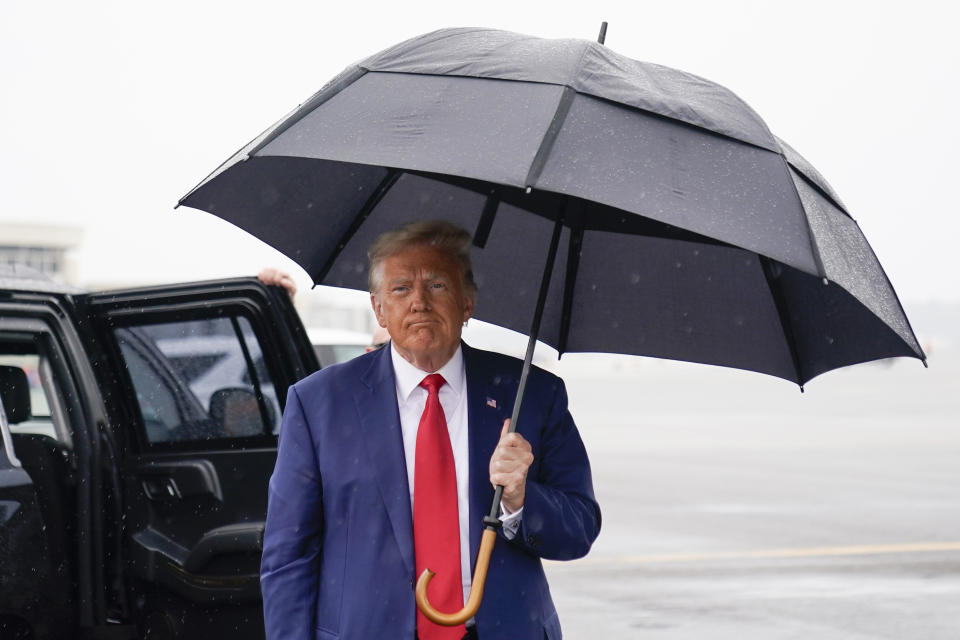 Former President Donald Trump walks over to speak with reporters before he boards his plane at Ronald Reagan Washington National Airport, Thursday, Aug. 3, 2023, in Arlington, Va., after facing a judge on federal conspiracy charges that allege he conspired to subvert the 2020 election. (AP Photo/Alex Brandon)