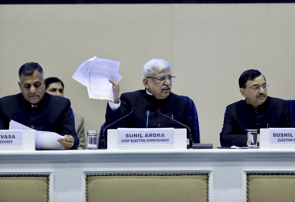 India's Chief Election Commissioner Sunil Arora, center, speaks during a press conference in New Delhi, India, Sunday, March 10, 2019. India's Election Commission has announced that the upcoming national election will be held in seven phases in April and May as Prime Minister Narendra Modi's Hindu nationalist party seeks a second term. (AP Photo/ Manish Swarup)