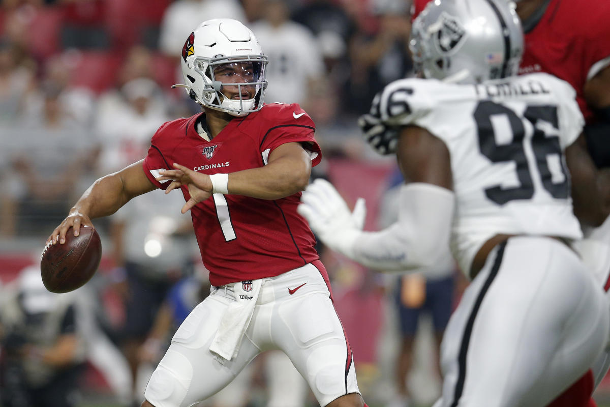 Arizona Cardinals' quarterback Kyler Murray (L) tries to dodge a