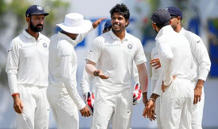 Sri Lanka v India - First Test Match - Galle, Sri Lanka - July 27, 2017 - India's cricketer Umesh Yadav celebrates with his teammates after taking the wicket of Sri Lanka's Dimuth Karunaratne (not pictured) . REUTERS/Dinuka Liyanawatte