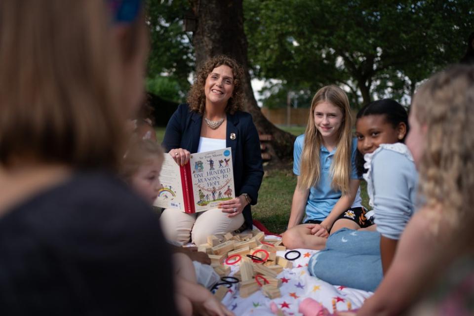 Captain Sir Tom Moore’s daughter Hannah Ingram-Moore reads to children who feature in One Hundred Reasons to Hope. (Joe Giddens/ PA) (PA Wire)