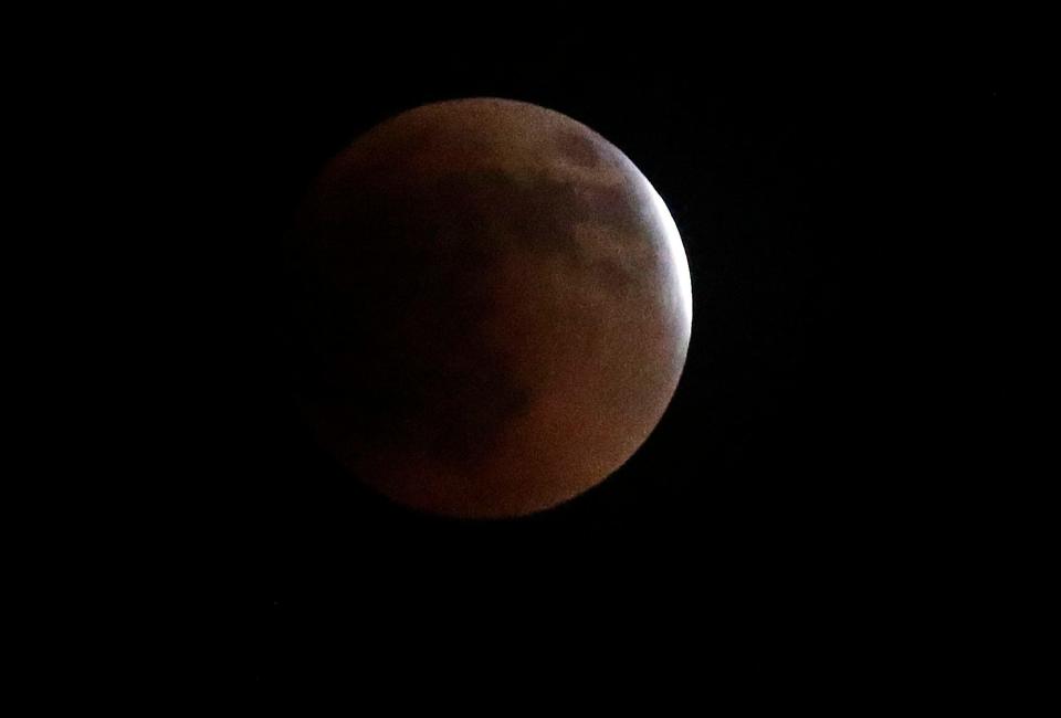 The super flower blood moon lunar eclipse is seen in the sky over Ashland County late Sunday night and into the wee hours of Monday morning.