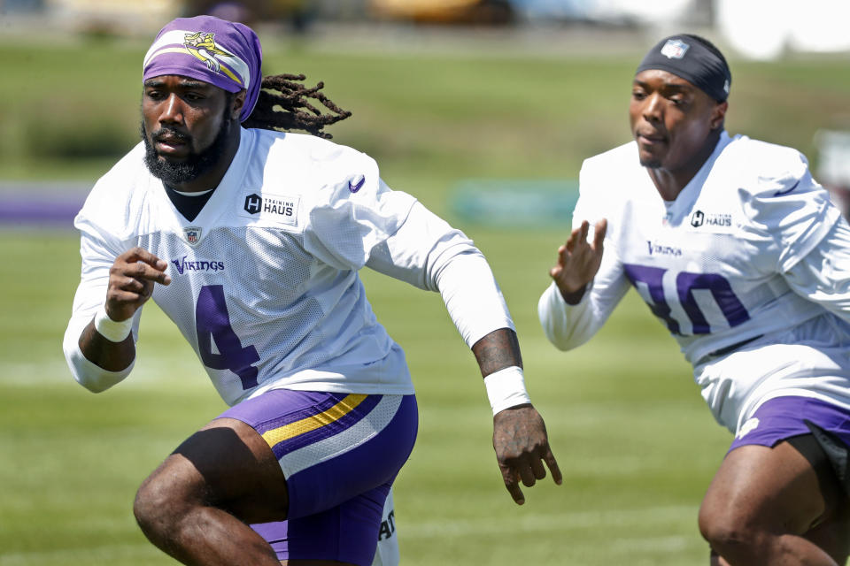 Minnesota Vikings running back Dalvin Cook (4) and fullback C.J. Ham (30) run drills at the NFL football team's practice facility in Eagan, Minn., Saturday,July 30, 2022. (AP Photo/Bruce Kluckhohn)