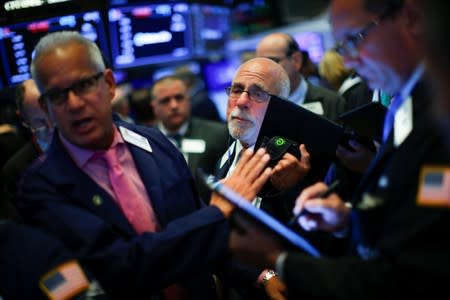 Traders work on the floor at the New York Stock Exchange (NYSE) in New York