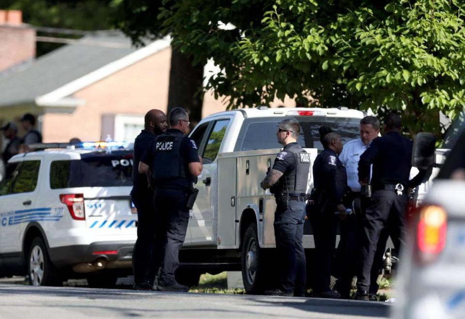 Police discuss among themselves at the scene where multiple law enforcement officers were shot in east Charlotte, NC on Monday, April 29, 2024.