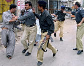 <p>Pakistani police officers detain the supporters of ethnic-Baluch tribal chief Nawab Akbar Bugti, who trying to hold a protest after the killing of their leader, Aug. 27, 2006 in Karachi, Pakistan. (AP Photo/Shakil Adil) </p>