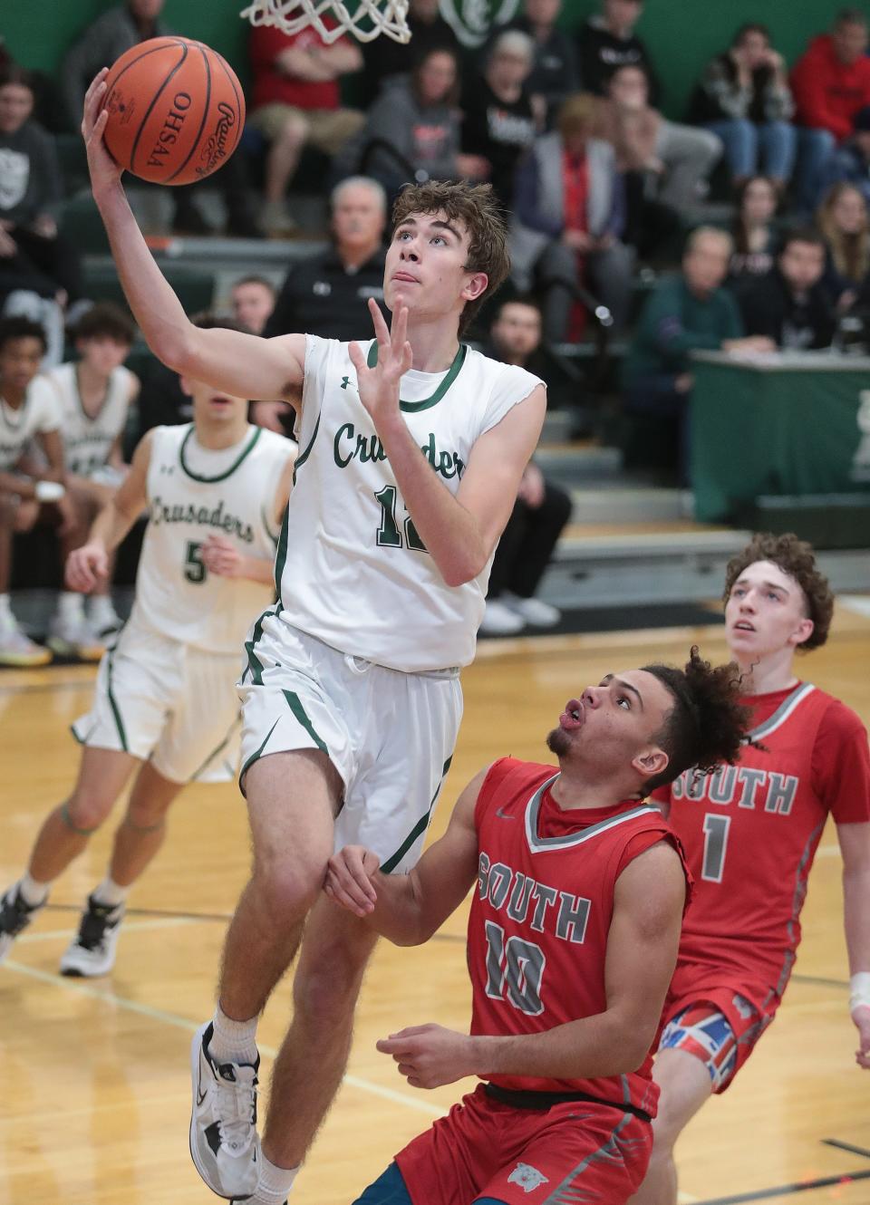 Central Catholic's Dylan Rouse drives for a layup vs. Canton South, Tuesday, Dec. 13, 2022.