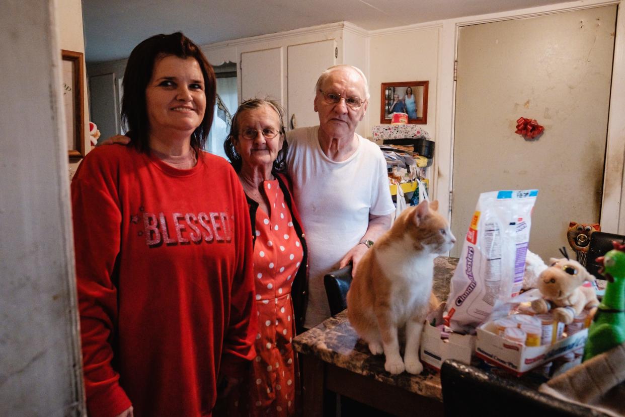 Times-Reporter carrier Michelle Lea Todd, left, poses for a portrait with Helen Harshey and William Halsey in their Uhrichsville home. Todd used a customer's tip to buy Thanksgiving dinner for them.