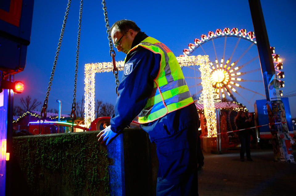 Police places concrete blocks at the entrance of a Christmas market in Berlin