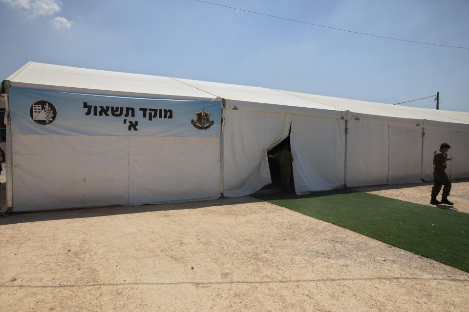 Inside this tent Israeli soldiers interview people infected with coronavirus over the phone to identify who they have been in contact with, at the headquarters of the Home Front Command, in Ramle, Central Israel, Tuesday, Aug. 25, 2020. As Israel struggles to control a coronavirus outbreak, it has called in the army to help. At the instruction of the country's coronavirus czar, the military set up a new "task force” that is playing a leading role in contact tracing and breaking the chain of infections. (AP Photo/Sebastian Scheiner)