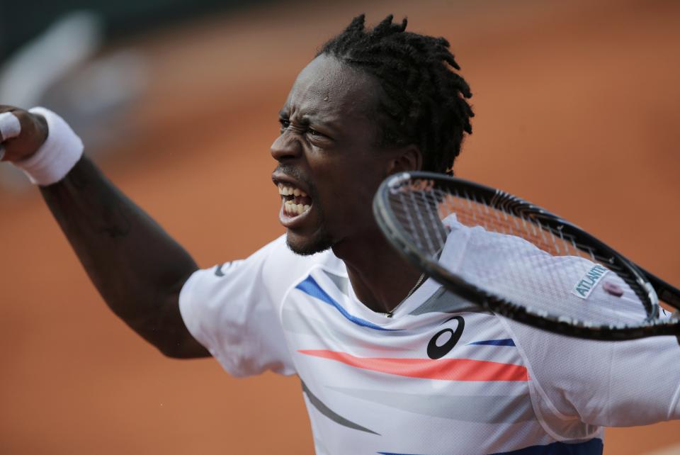 Gael Monfils of France celebrates his victory over Fabio Fognini of Italy in their men's singles match at the French Open tennis tournament at the Roland Garros stadium in Paris