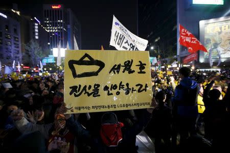 A mourner holding up a banner marches during a rally to commemorate the first anniversary of the Sewol ferry disaster that killed more than 300 passengers, in central Seoul April 16, 2015. REUTERS/Kim Hong-Ji