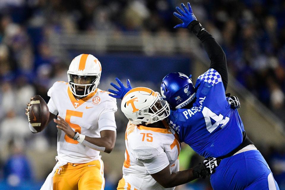 Tennessee quarterback Hendon Hooker (5) looks to pass as Tennessee offensive lineman Jerome Carvin (75) defends against Kentucky defensive end Josh Paschal (4) during an SEC football game between Tennessee and Kentucky at Kroger Field in Lexington, Ky. on Saturday, Nov. 6, 2021.