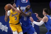 Los Angeles Lakers' Anthony Davis (3) works against Dallas Mavericks' Dorian Finney-Smith (10) and Luka Doncic, right, for a shot in the first half of an NBA basketball game in Dallas, Thursday, April 22, 2021. (AP Photo/Tony Gutierrez)