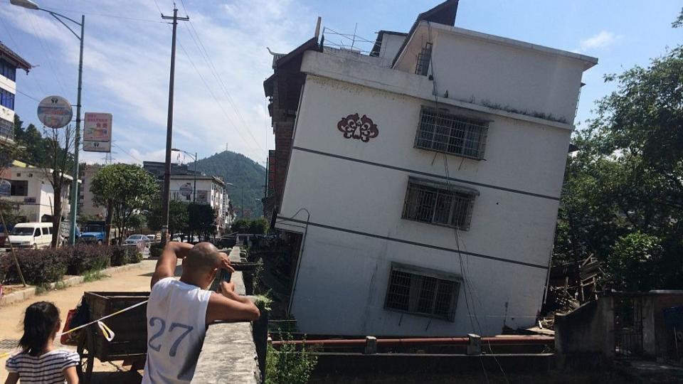 Residents watch as buildings subside and lean in China's Guangxi province.