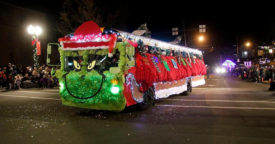 An Ashland City School bus is decorated like the Grinch in Ashland's 2021 Christmas parade is seen heading down Claremont Avenue at West Main Street on Saturday, Dec. 4, 2021. TOM E. PUSKAR/TIMES-GAZETTE.COM