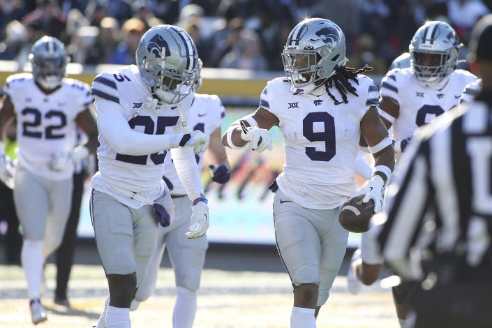Kansas State safety Cincere Mason (9) and Kansas State cornerback Ekow Boye-Doe celebrate after a touchdown during the first half of an NCAA college football game against West Virginia in Morgantown, W.Va., Saturday, Nov. 19, 2022. (AP Photo/Kathleen Batten)
