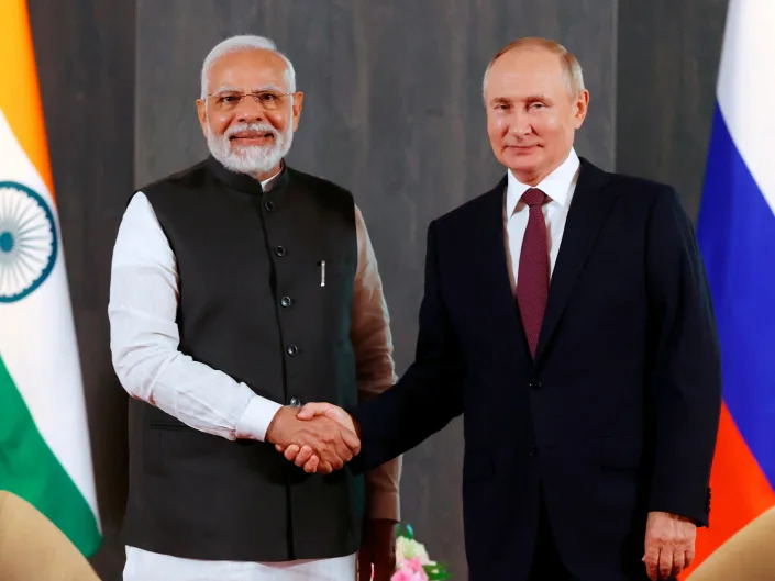 Russian President Vladimir Putin, right, and Indian Prime Minister Narendra Modi pose for a photo shaking hands prior to their talks on the sidelines of the Shanghai Cooperation Organisation (SCO) summit in Samarkand, Uzbekistan, Friday, Sept. 16, 2022.