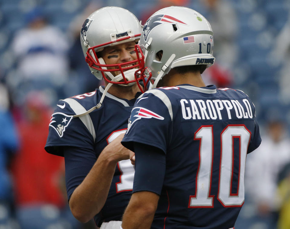 Tom Brady, pictured with Jimmy Garoppolo, is showing no signs that retirement is near. (AP) 