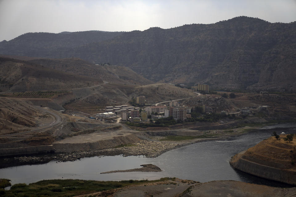 Tigris river flows from the Ilisu Dam reservoir is seen in Mardin province, Turkey, Tuesday, Oct. 18, 2022. Before Turkey began operating the dam in May 2020, all the waters of Tigris River flowed into Iraq. Now how much water comes down depends on Ankara's consideration of Iraq's month-to-month requests for a minimum flow, weighed against Turkey's own needs. (AP Photo/Khalil Hamra)