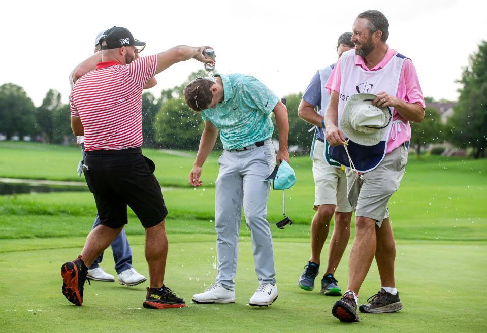Taylor Moore gets doused with beer after sinking his putt on the No. 18 hole to finish at 27-under and win the Korn Ferry Tour’s Memorial Health Championship last Sunday.