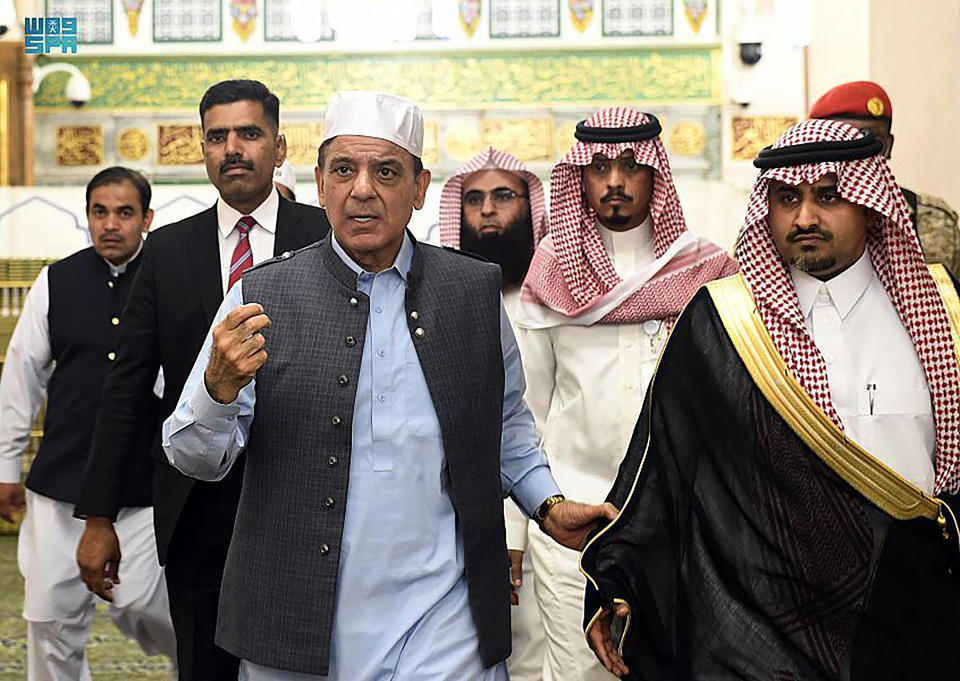 Prime Minister of Pakistan Shahbaz Sharif, third left, visits Prophet Muhammad’s mosque in the holy city of Medina in western Saudi Arabia and performs prayers with his delegation late Thursday, April 28, 2022. Pakistan’s newly elected prime minister was visiting Saudi Arabia Friday on his first foreign trip since taking office, an attempt to boost economic relations with the wealthy, oil-rich kingdom as Pakistan struggles with huge debt, soaring inflation and a worsening energy crisis. (Saudi Press Agency via AP)