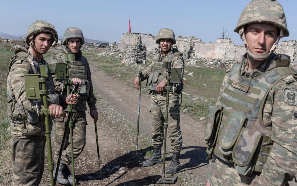 Azerbaijani sappers take a break after sweeping a field of mines near the construction site of new airport in the destroyed town of Fuzuli -  Sam Tarling/The Telegraph