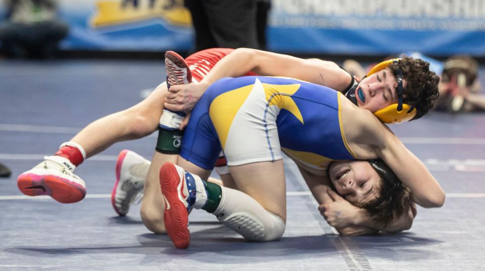 Holland Patent sophomore Andrew Juliano (foreground) defeated Tioga's Declan McKee in a 101-pound semifinal match Saturday at the NYSPHSAA wrestling championships.