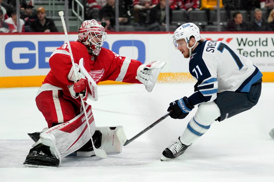 Detroit Red Wings goaltender Alex Nedeljkovic (39) defends Winnipeg Jets left wing Evgeny Svechnikov (71) in the first period at Little Caesars Arena in Detroit on Thursday, Jan.  13, 2022.