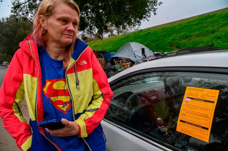 Homeless mom Alice’a Stanley’s eyes fill with tears as her car was tagged by city crews along Lathrop Way in Sacramento on Wednesday. Another car she was going to sell was towed on Monday. “I have pneumonia and I can’t walk very far. I don’t know what to do,” she said.