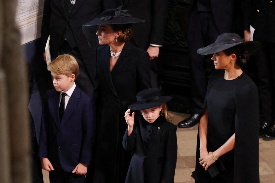 LONDON, ENGLAND - SEPTEMBER 19: Catherine, Princess of Wales, Princess Charlotte of Wales, Prince George of Wales and Meghan, Duchess of Sussex arrive at Westminster Abbey for the State Funeral of Queen Elizabeth II on September 19, 2022 in London, England.  Elizabeth Alexandra Mary Windsor was born in Bruton Street, Mayfair, London on 21 April 1926. She married Prince Philip in 1947 and ascended the throne of the United Kingdom and Commonwealth on 6 February 1952 after the death of her Father, King George VI. Queen Elizabeth II died at Balmoral Castle in Scotland on September 8, 2022, and is succeeded by her eldest son, King Charles III. (Photo by Phil Noble - WPA Pool/Getty Images)