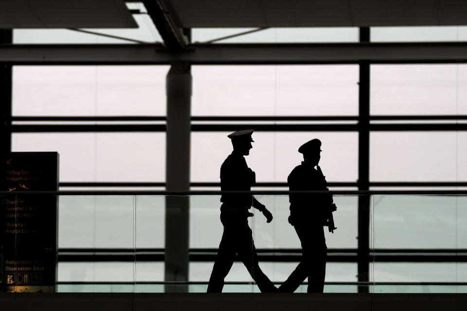 Police officers guard the deserted departure terminal during a strike in Bavaria at the airport in Munich, Germany, Sunday, March 26, 2023. An increased number of travelers in Germany boarded trains and planes on Sunday to avoid a massive one-day strike Monday that's supposed to bring the country's transport system to a standstill. But even advance travels were met with disruptions in some places as Munich airport already shut down Sunday due to the strike and technical problems at Lufthansa in Frankfurt led to flight delays and cancellations at the country's biggest airport. (AP Photo/Matthias Schrader)