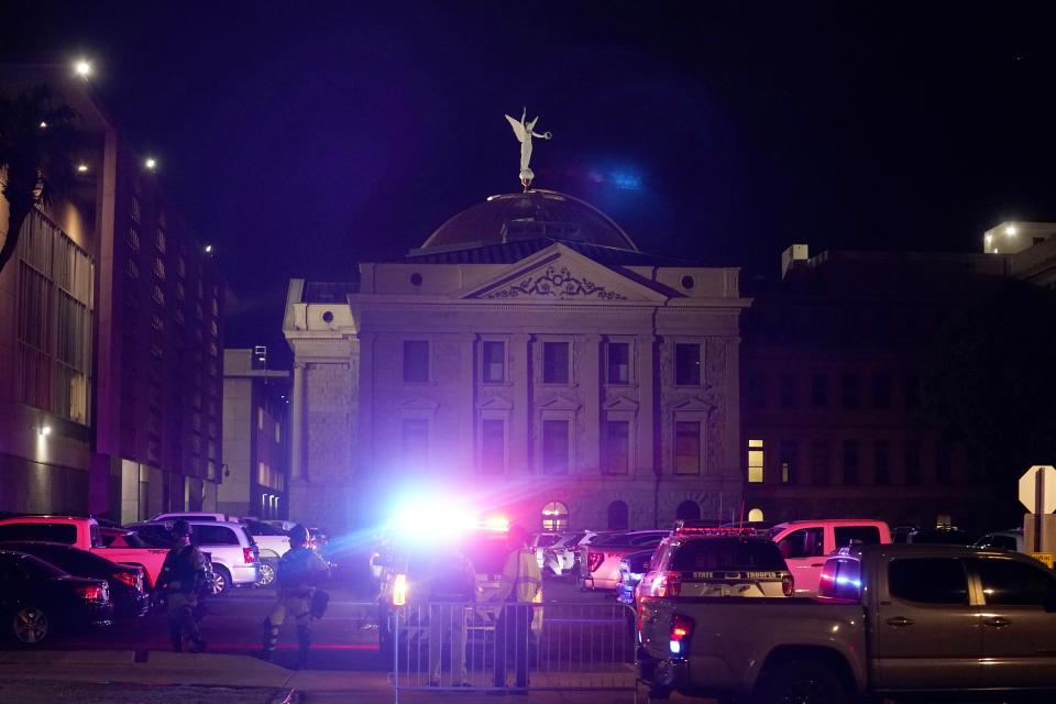 A large number of police surround the Arizona Capitol after protesters reached the front of the AZ Senate building following the Supreme Court's decision to overturn Roe v. Wade Friday, June 24, 2022, in Phoenix. (AP Photo/Ross D. Franklin)