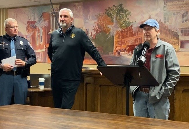 Mayor Bob McCoy (right) speaks at a March 15 press conference at Winchester City Hall as Doug Carter, superintendent of the Indiana State Police (left) and Governor Eric Holcomb look on.