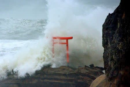 High waves triggered by Typhoon Lionrock crash against a "torii" gate on a coast of the city of Iwaki, Fukushima Prefecture, Japan, in this photo taken by Kyodo August 30, 2016. Mandatory credit Kyodo/via REUTERS