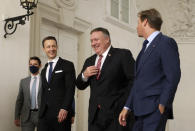 U.S. Secretary of State Mike Pompeo, second right, Austrian Finance Minister Gernot Bluemel, second left, and U.S. ambassador to Austria Trevor Traina, right, arrive for a business roundtable at the Winter Palace in Vienna Austria, Friday Aug. 14, 2020. Pompeo is on a five-day visit to central Europe. (Lisi Niesner/Pool via AP)