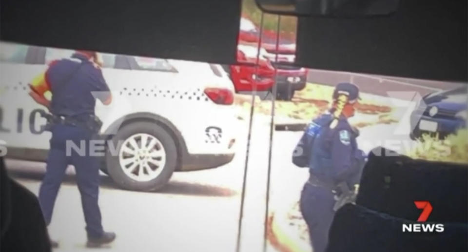 Police appear on scene outside a bus, where two girls were arrested.