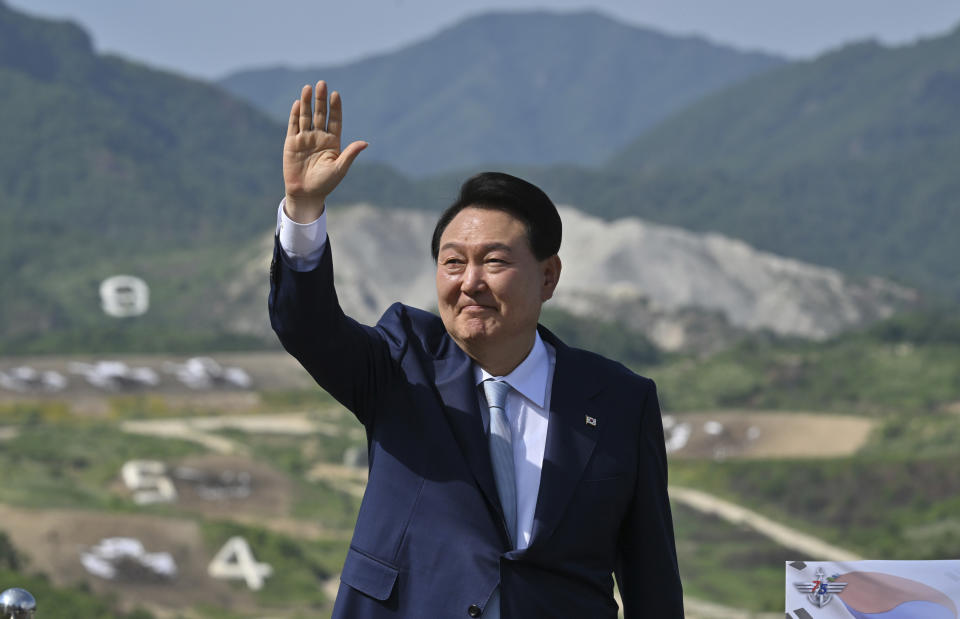 South Korean President Yoon Suk Yeol waves as he delivers a speech after a South Korea-U.S. joint military drill at Seungjin Fire Training Field in Pocheon, South Korea Thursday, June 15, 2023. (Jung Yeon-je/Pool Photo via AP)